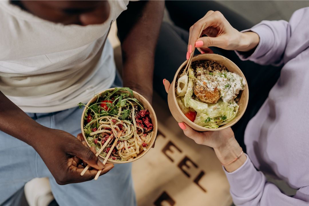 Two users sharing macro-balanced meals, highlighting Unchecked Fitness’s AI meal planning and real-food protein tracking for social and fitness-focused eating.